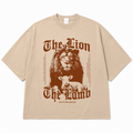 Beige t-shirt with lion and lamb graphic and text on a white background