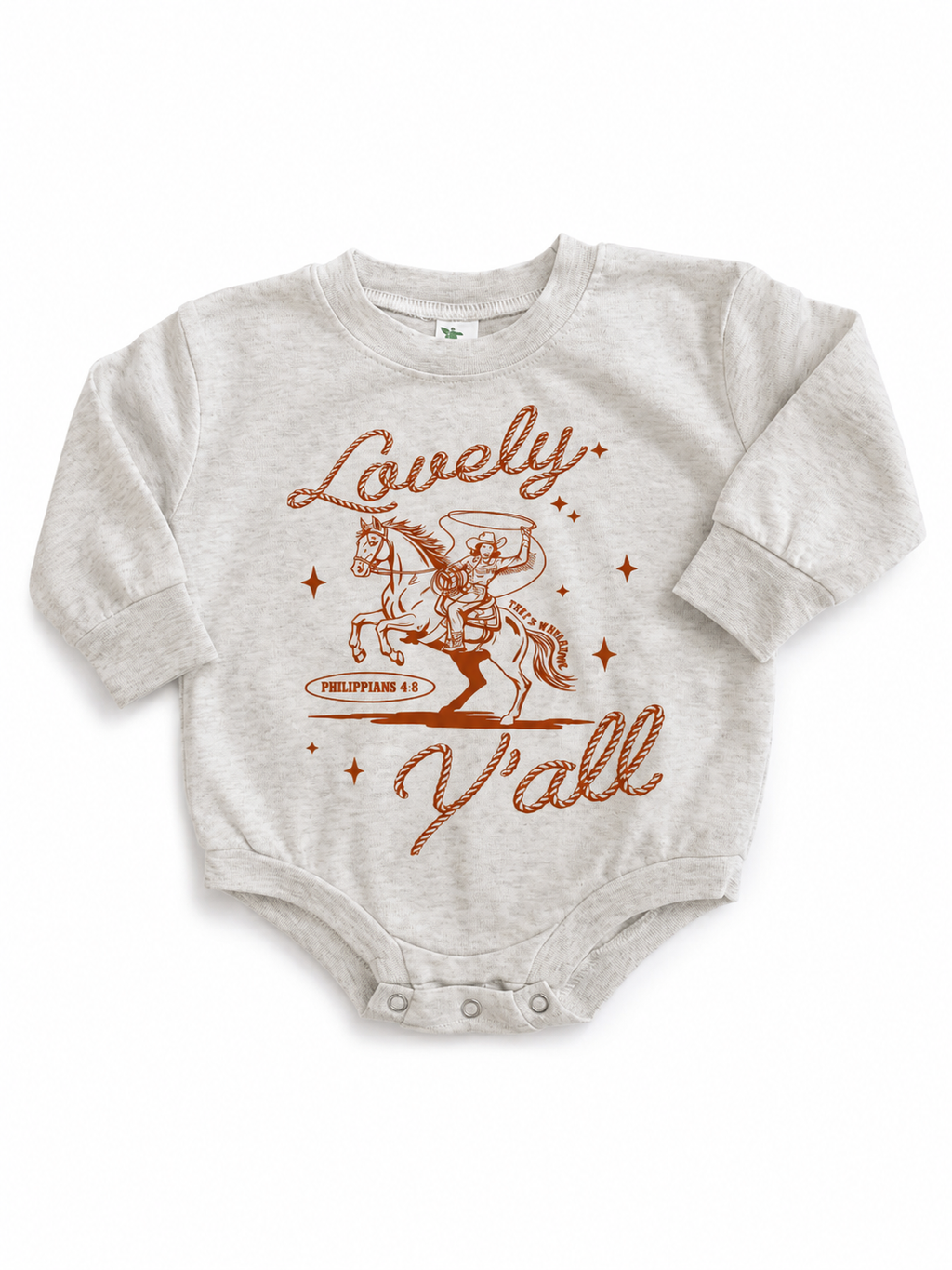 Beige long-sleeve baby onesie flat lay with a rust-colored graphic of a cowboy on a rearing horse, the script text "Lovely" and "Y'all," and "Philippians 4:8" beneath the horse.
