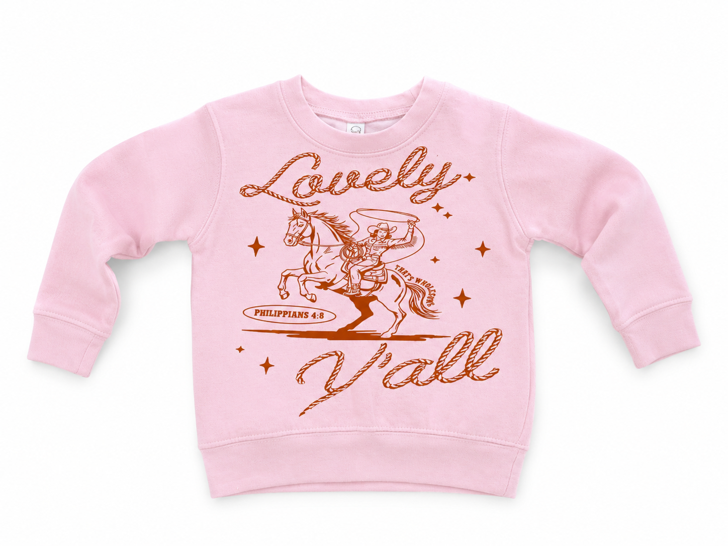 Pink toddler fleece crewneck flat lay with a rust-colored graphic of a cowboy on a rearing horse, the script text "Lovely" and "Y'all," and "Philippians 4:8" beneath the horse.